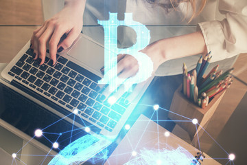 Double exposure of woman hands typing on computer and crypto market theme hologram drawing....