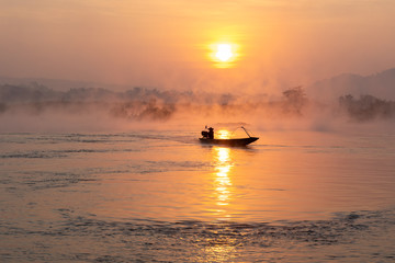 Silhouette Fisherman Fishing Nets on the boat,Fishing and outdoor activities concept.