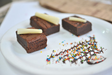 Brownie with white chocolate. Coffee desserts. Delicious dessert with coffee.