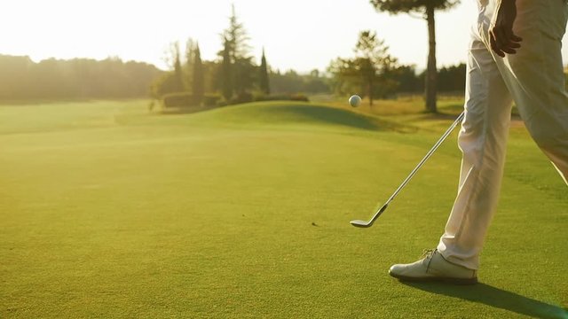 Golfer playing juggle with his club