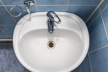 sink with faucet in bathroom with blue tile on walls