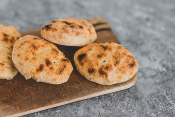 healthy simple food from pantry ingredients, small homemade bread rolls on cutting board on grey