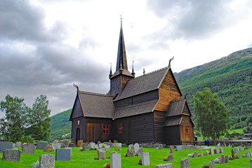 Fototapeta na wymiar A stave church, made completely of wood, and church yard cemetery, in Norway