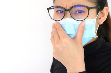 Shot of young Asian woman worring and wearing mask for protect bad air pollution or virus. Air pollution has been associated with diseases of the heart and lungs, cancers and other health problems.
