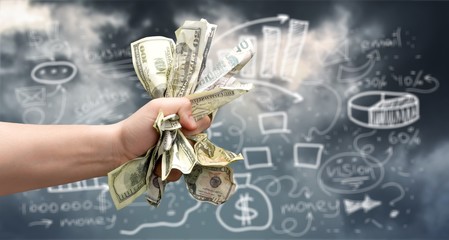 Dollar banknotes in human hand on business background