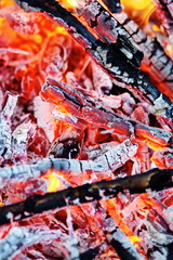 Burning coals colored red, white, black, yellow, and orange.  