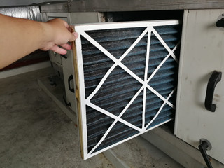 Soft Focus to Filter of Air handing Unit, Technician checking a Pre-filter of air handling unit for...