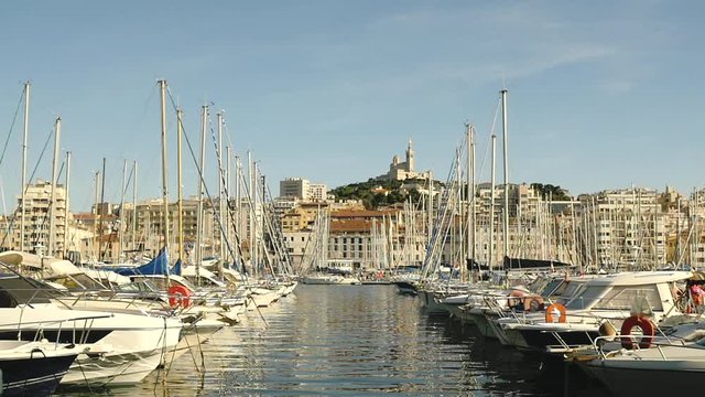 Marseille's harbor with famous Bonne Mère church in the background