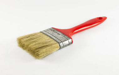 Old and used red paint brush isolated on white background.