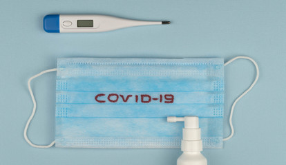 stop the global pandemic COVID-19. Coronavirus prevention surgical masks and electronic thermometer