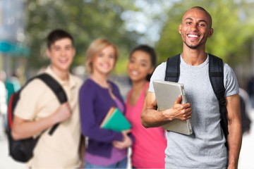 Smiling young college student with laptop