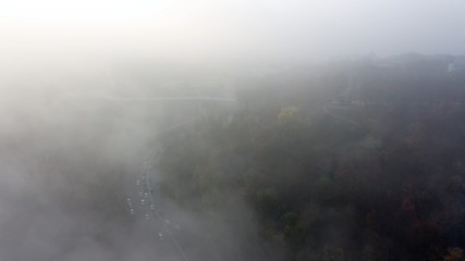 A city covered in fog. City traffic, aerial view