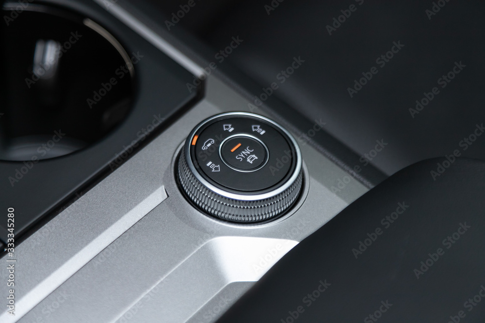 Poster close up shot of modern central console with suspension and traction control buttons