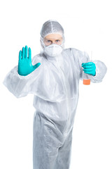 Infection control expert in protective suit and respirator with flask and liquid in hand. showing a gesture of hand stop. Isolated