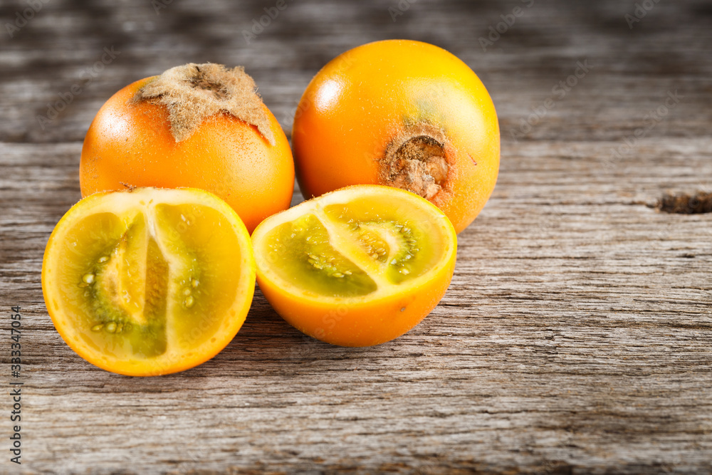 Wall mural fruit of lulo or naranjilla on wood