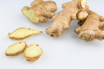 Fresh organic root ginger with slices isolated on white background. Natural anti virus medicine supports immune system