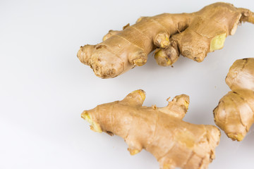 Fresh organic root ginger with slices isolated on white background. Natural anti virus medicine supports immune system