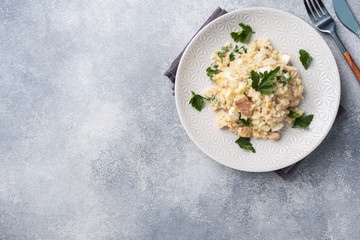 Salad of boiled rice, red fish pink salmon eggs and greens on a plate. Copy space
