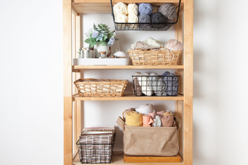 Different sewing supplies and yarn lie in baskets