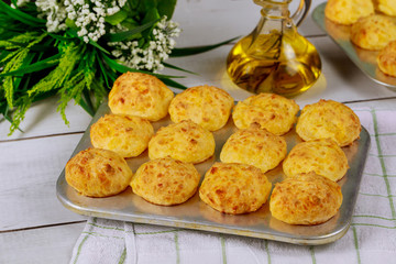 Cooked brazilian cheese bread in baking pan with oil.