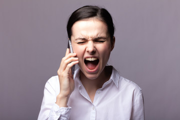 girl in a white shirt communicates on the phone