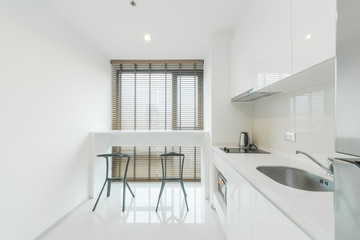 Stylish kitchen interior with dining table and chairs