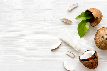 Face care. Coconut cream in glass jar on white background top-down frame copy space