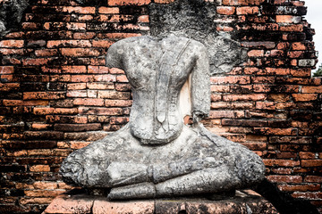 The broken Buddha Image in Ayutthaya historical park, Thailand. - obrazy, fototapety, plakaty