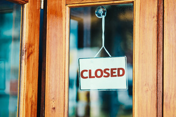 text Closed sign on door of cafe. The impact from the epidemic of CORONAVIRUS (COVID-19).