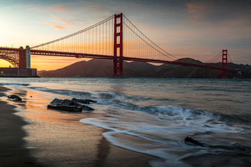 Sunset at the beach by the Golden Gate Bridge in San Francisco California