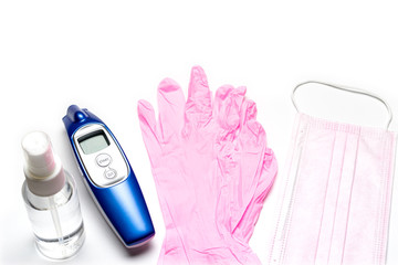 Medical background white. Medical surgical mask, sanitizer gel and lab gloves, modern thermometer on Virus protection equipment. Dangerous asian ncov corona virus. Novel Coronavirus 2019-nCoV