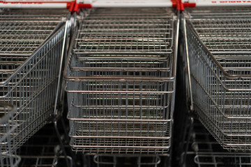 Lots of empty shopping carts in a row. concept buyer in super market.