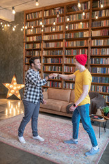 Two young handsome men standing in the middle of the room