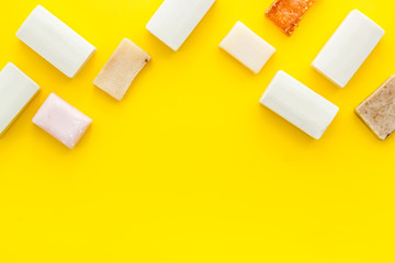 Soap bars flat lay on yellow background top-down copy space frame