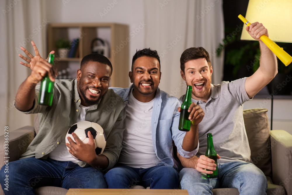 Sticker friendship, sports and entertainment concept - happy male friends with soccer ball, beer and vuvuzela supporting football team at home