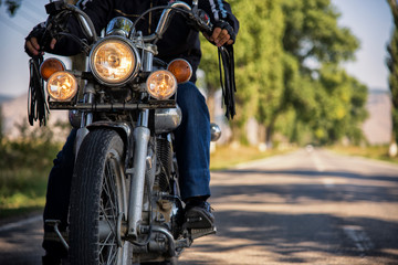 Motorcycle closeup passing by on the road with lights on