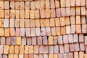 Stack of red clay bricks background