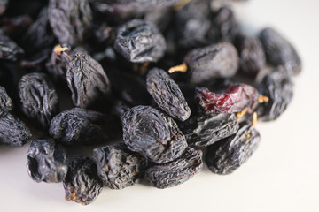 dry raisins on a white table