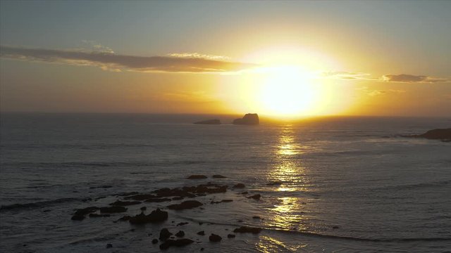 Aerial drone descending shot of the sunset off of the coast of San Simeon, California, USA