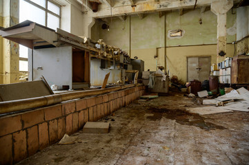 Fototapeta na wymiar Photo of a slum in an abandoned broken devastation plant. Landfill in the workshop.
