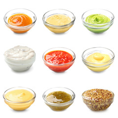 Different tasty sauces in bowls on white background