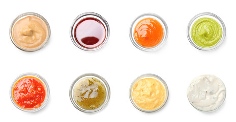 Different tasty sauces in bowls on white background - obrazy, fototapety, plakaty