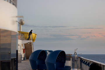 A crew member in the open deck of a cruise ship after the ship was evacuated 