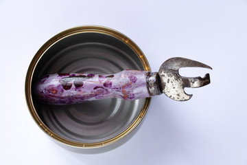 soviet tin can opener with wooden painted handle on white