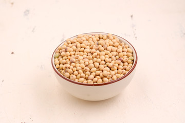 Soy bean in bowl on floor and copy space.soybeans dry on white backdrop.