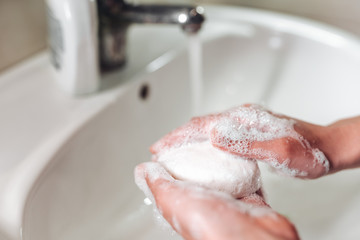 Man washing hands to protect against the coronavirus