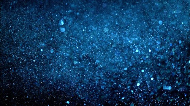 silver rain on a black background . Golden Particles ( glitters background ) . loop 4K 3840X2160 UHD video. Macro view.