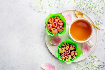 A cup of tea with tulips on white background