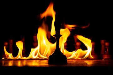 chess board on fire with figures in the dark, front and background blurred with bokeh effect