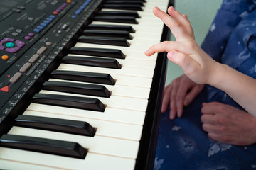 little hands black white piano keys synth close-up